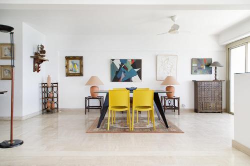 un salon avec des chaises jaunes et une table dans l'établissement On la Croisette XXL 1 bedroom with amazing sea view, à Cannes