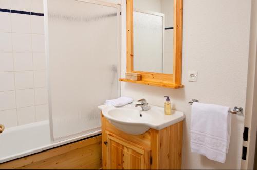 a bathroom with a sink and a mirror at Olydea Fontaine du Roi in Saint-Jean-dʼArves