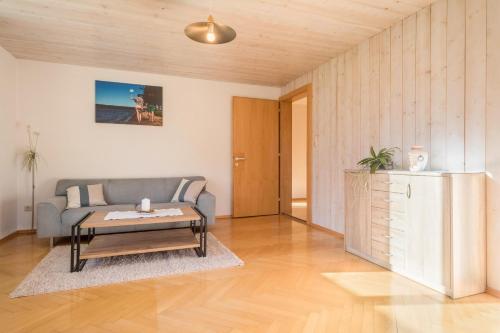 a living room with a couch and a coffee table at Wohnung Kanisfluhblick in Bizau