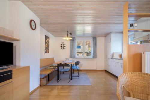a kitchen and dining room with a table and chairs at Wohnung Kanisfluhblick in Bizau