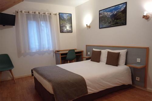 a hotel room with a large bed and a window at Hôtel de la Gare in Pierrefitte-Nestalas