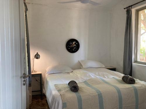 a bedroom with two beds with hats on top of them at Kleinkloof Farm in Piketberg