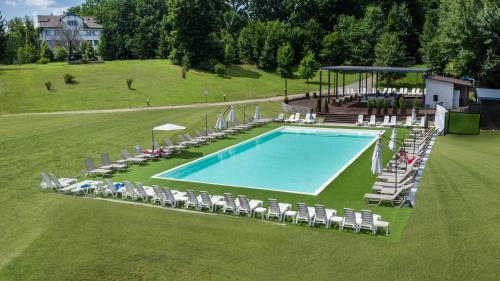 an overhead view of a swimming pool with lounge chairs at Optima Collection Aquadar in Manʼkivka