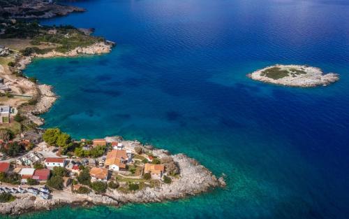 an aerial view of a small island in the water at Kokkinos Studios in Skinária