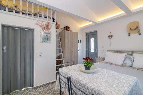 a white room with a table and a bed at Kokkinos Studios With Pool & Sea View, by ZanteWize in Skinária