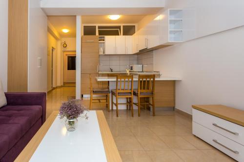 a living room and kitchen with a couch and a table at Holiday Home in Komarna