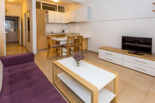 a living room with a couch and a table at Holiday Home in Komarna