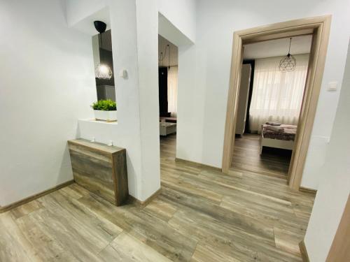 a hallway with white walls and a wooden floor at Aparthouse Heaven in Sandanski