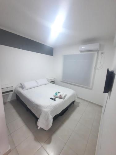a white bedroom with a bed in a room at Home Zafiro I in Santa Fe