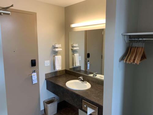 a bathroom with a sink and a mirror at SureStay Hotel by Best Western Bassano in Bassano