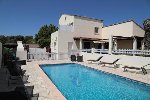 a swimming pool in front of a house at Songe de Thau in Balaruc-le-Vieux
