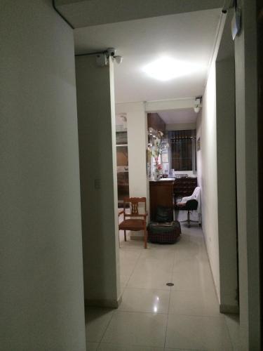 a hallway leading to a living room and a dining room at Hotel Viña del Mar in Tacna