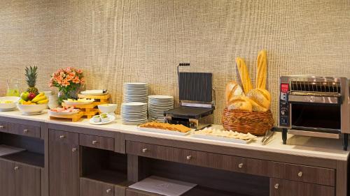 a buffet with bread and other food on a table at Hotel Atacama Suites in Copiapó