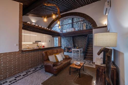 a living room with a couch and a table at Barrote Beja- Alojamento Local in Beja