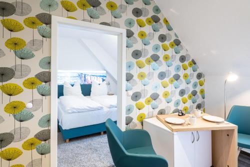 a bedroom with a mirror and a bed and a desk at Altes Wasserwerk, FW 7 in Zingst
