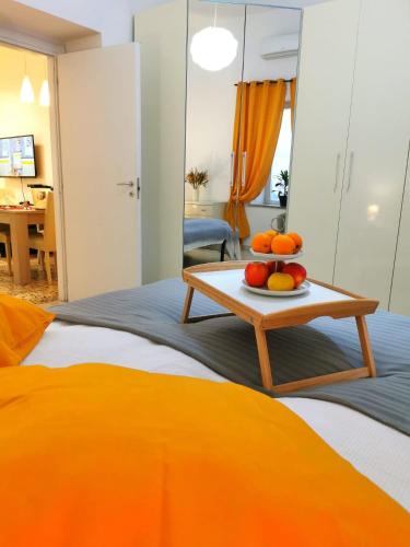 a room with a bed with a table with fruit on it at Villa Valentino Pompeji in Pompei