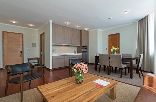 a living room and a kitchen with a table at Hotel Atacama Suites in Copiapó