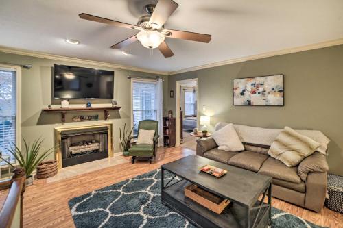 a living room with a couch and a fireplace at Lake Barkley Home with Fire Pit and Private Dock! in Cadiz
