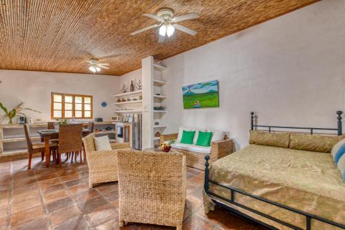 a bedroom with a bed and a dining room at Boutique Hotel Secret Garden Granada in Granada