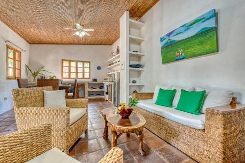 a living room with wicker chairs and a couch at Boutique Hotel Secret Garden Granada in Granada