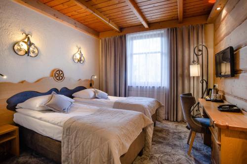Posteľ alebo postele v izbe v ubytovaní Hotel Sabała