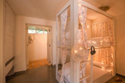 a bathroom with a shower and a ladder with towels at Moustache Goa Luxuria in Vagator