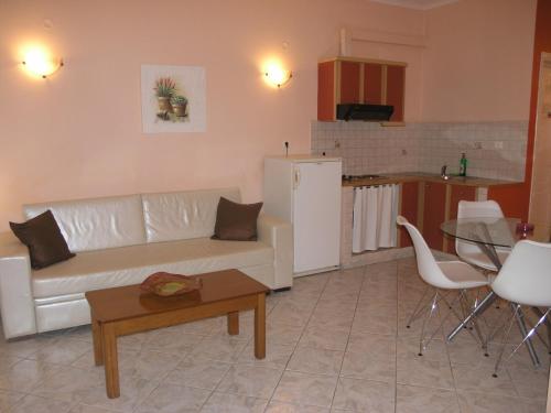 a living room with a white couch and a table at Filoxenia Sea View in Parga