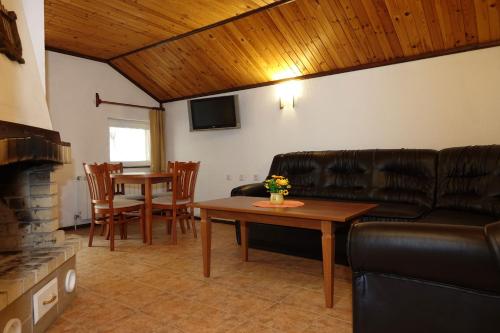 a living room with a couch and a table at Семеен хотел Орфей in Teshel