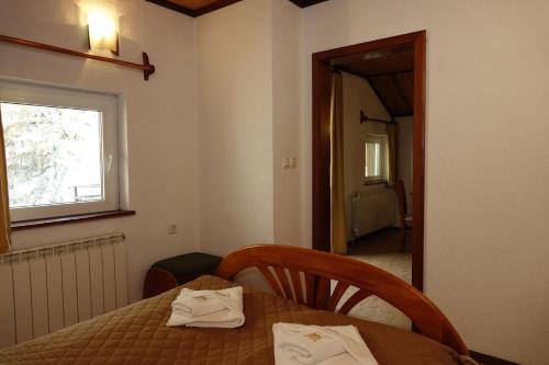 a dining room with a table and a window at Семеен хотел Орфей in Teshel