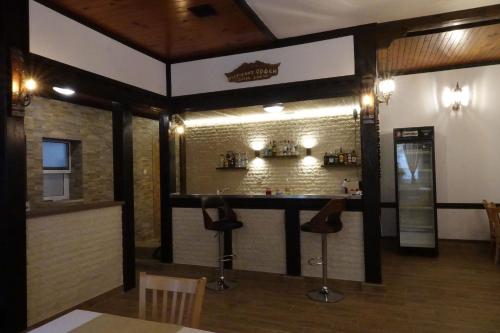 a bar in a restaurant with a brick wall at Семеен хотел Орфей in Teshel