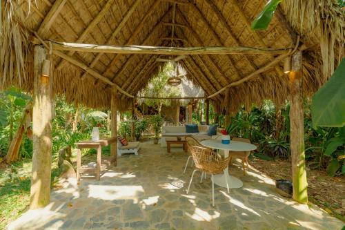 a pavilion with a table and chairs in a garden at El Valle Lodge in El Valle