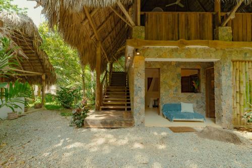 a house with stairs and a blue couch in front at El Valle Lodge in El Valle