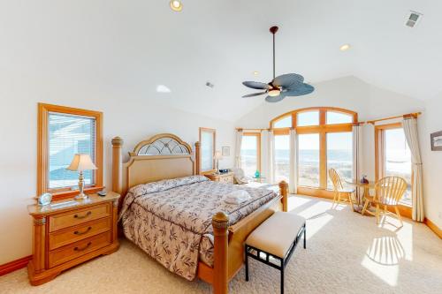 a bedroom with a bed and a table and chairs at Pinch Me #12H in Hatteras