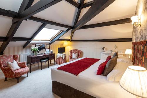 a bedroom with a large bed and a desk at Ees Wyke Country House in Near Sawrey