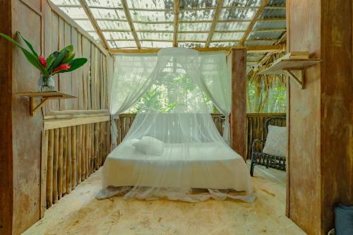 a bedroom with a bed with a canopy and a window at El Valle Lodge in El Valle