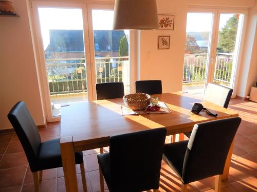 a dining room with a wooden table and chairs at Ferienwohnung am Plauer See - a55900 in Alt Schwerin