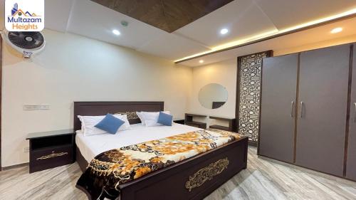 a bedroom with a large bed in a room at Multazam Heights, DHA Phase 8 - 3 Bedrooms Luxury Apartments in Lahore