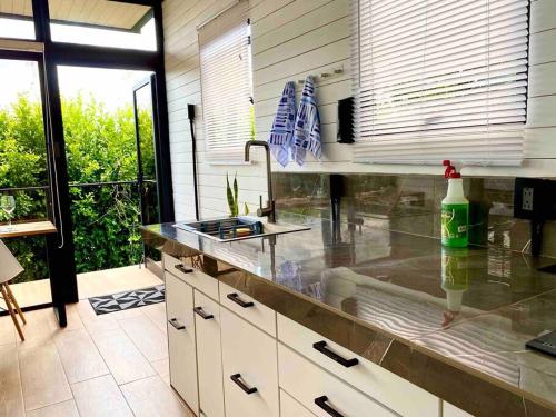 a kitchen with a sink and a counter top at Hoja Azul Loft Guanacaste in Hojancha