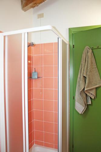 a bathroom with a shower with green and orange tiles at Agriturismo Fiorbello in Montirone