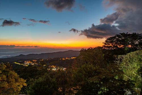 a view of a city at sunset at Ocotea Boutique Hotel in Monteverde Costa Rica
