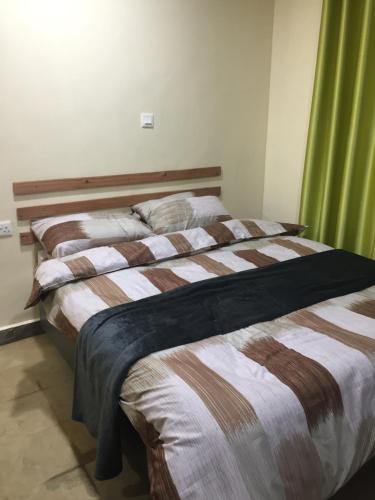 Postel nebo postele na pokoji v ubytování Bubbles Lodge Kinangop
