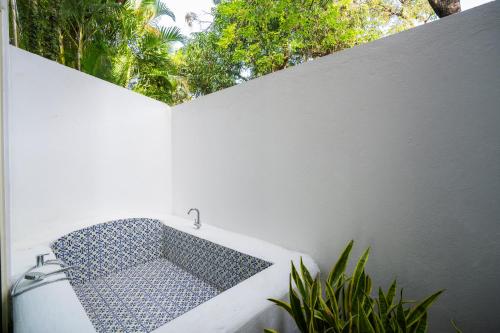 a white wall with a sink in a bathroom at Moustache Goa Luxuria in Vagator