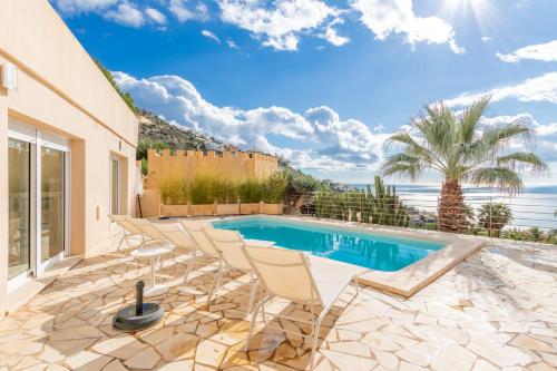 a villa with a swimming pool and a patio at Altea Hills , Villa Noruega in Altea