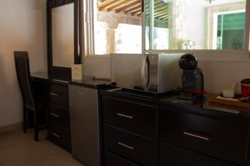 a kitchen with a dresser with a coffee maker on it at Finca del Rocio in Parras de la Fuente
