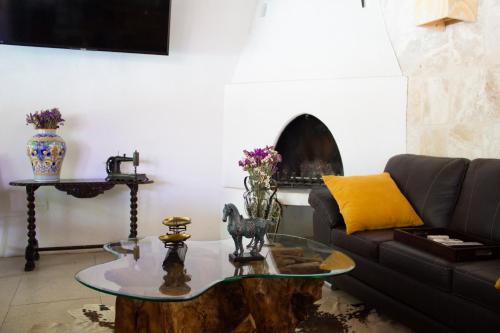 a living room with a couch and a table at Finca del Rocio in Parras de la Fuente