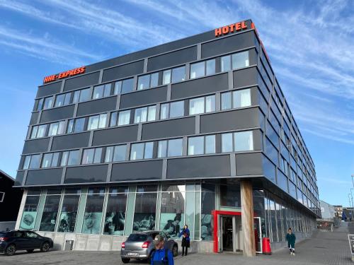 a black building with people standing outside of it at HHE Express in Nuuk