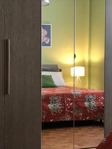 a bedroom with a bed and a glass cabinet at B&B Ospedale Maggiore Parma affittacamere in Parma