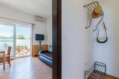 a living room with a blue couch and a balcony at Vila Bicikleta Istra in Peroj