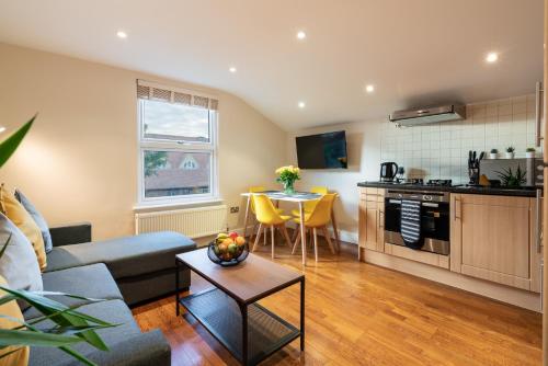 a living room with a couch and a table at 1bd apt for 2-4. New flooring & furnishings in Enfield