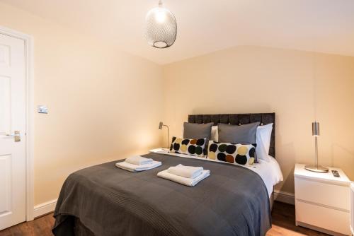 a bedroom with a bed with two towels on it at 1bd apt for 2-4. New flooring & furnishings in Enfield